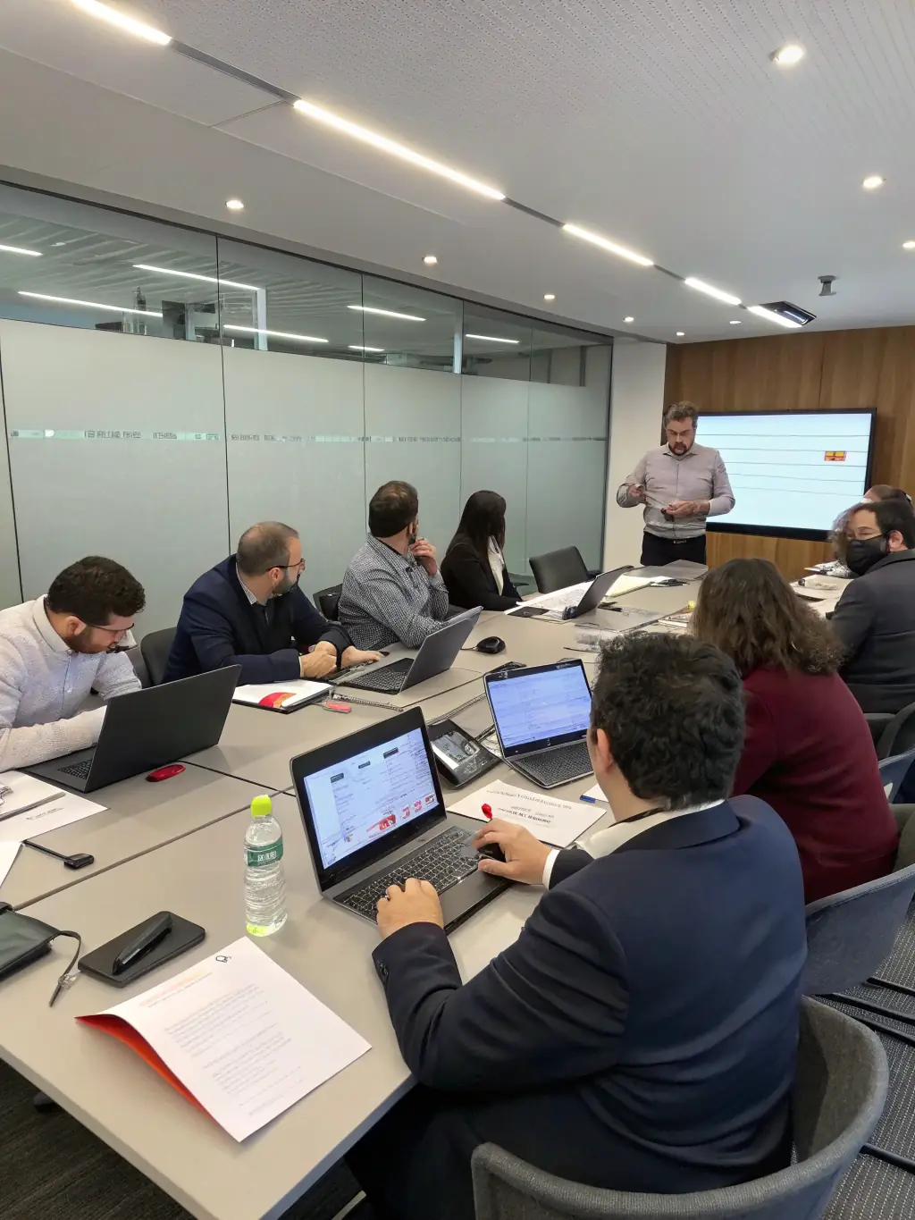 A coach is facilitating a soft skills training session, focusing on communication and teamwork in a British workplace.